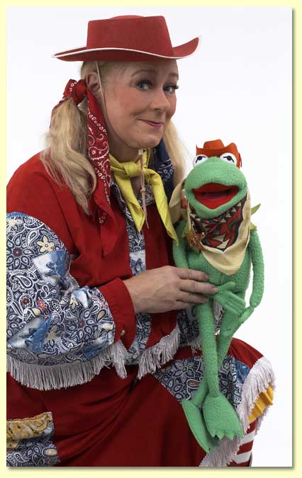 Photograph of Bucky the Cowgirl with a frog puppet.