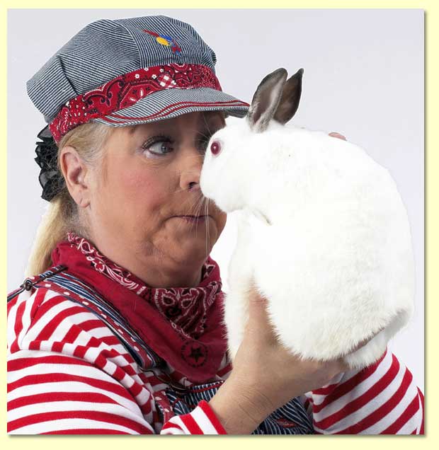 Photo of Margaret Clauder as engineer maggie holding her white rabbit.