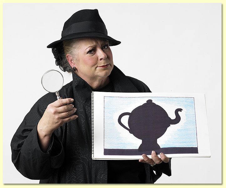Photo of Imma Sleuth, a Texas Library Association edutainer in a black trenchcoat, with magnifying glass.