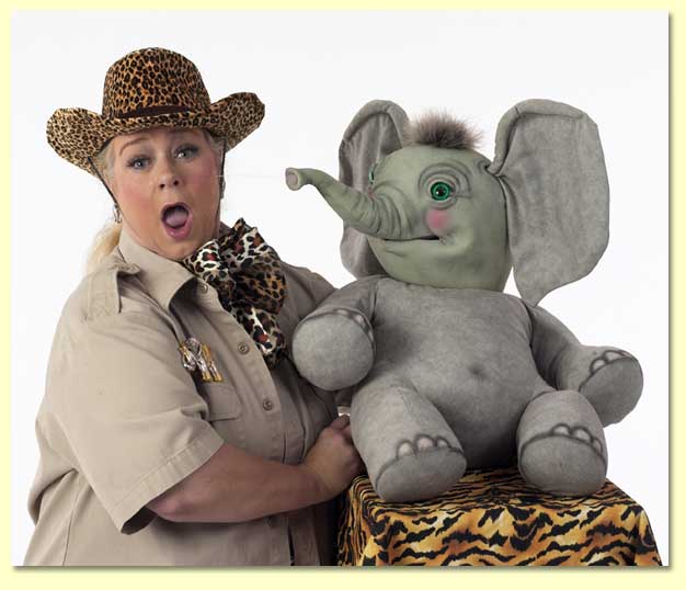 Large photo of Masai Maggie getting squirted by Sneezy the elephant puppet, available for library reading shows in Texas.
