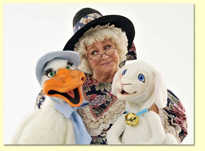 Photograph of the Original Mother Goose, a Texas entertainer, listening to her puppets.