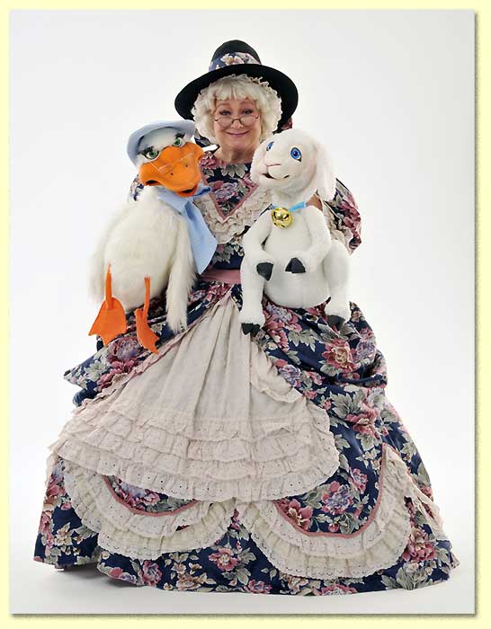Photograph of Mother Goose; played by Margaret Clauder; with her Axtel puppets Goosey and Lamby.