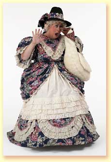 Thumbnail photo of Margaret Clauder dressed as Mother Goose, getting her nose pinched by Goosie the hand puppet.