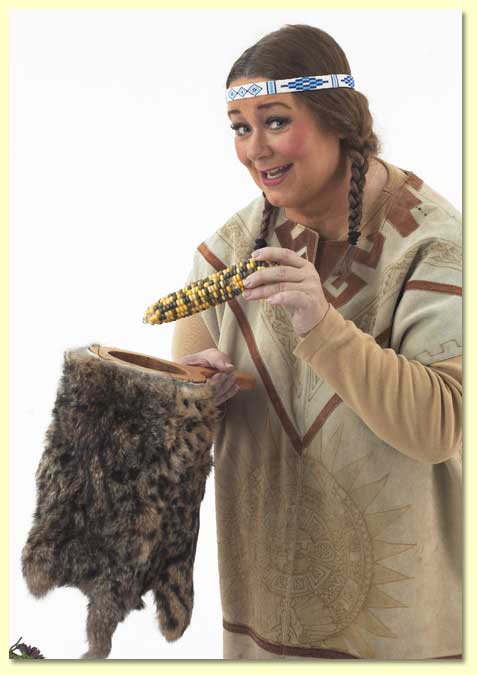 Photo of Singing Bird, a character played by Margaret Clauder, holding Indian corn.