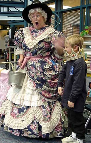 Photograph of Mother Goose with a boy helper.