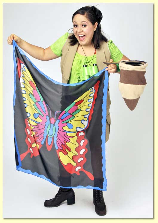Photograph of the Bug Lady holding a butterfly silk she made magically appear during her show.